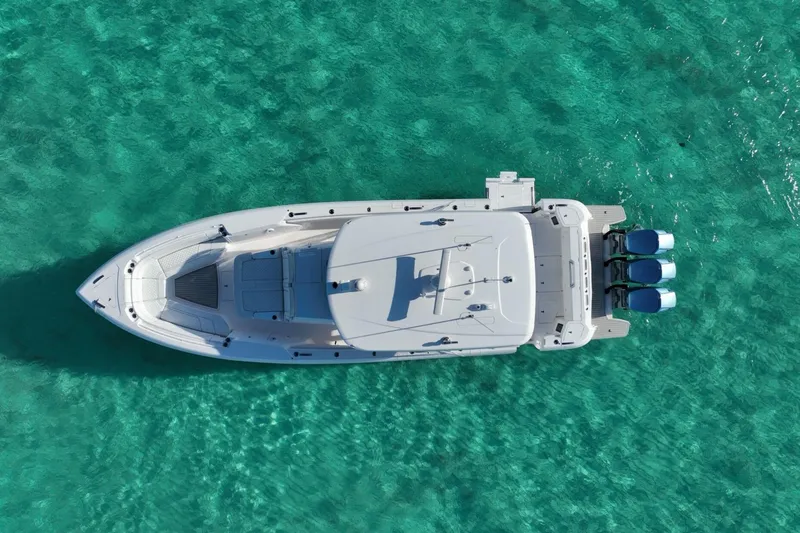 Slide: The Image of 2023 Intrepid 427 Nomad SE cruising on ocean with city skyline in background. - 8