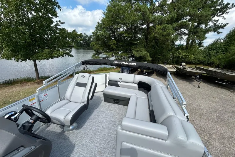 Slide: The Image of 2026 Sun Tracker Party Barge 20 Classic Series pontoon boat by a scenic lake. - 8
