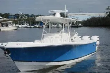 Slide: The Image of 2019 Regulator 34SS boat with blue hull on a calm waterway. - 1