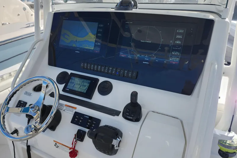 Slide: The Image of 2019 Regulator 34SS boat dashboard with advanced navigation and control systems. - 12