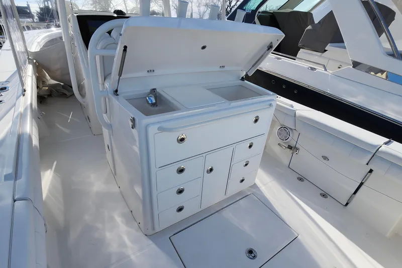 Slide: The Image of 2019 Regulator 34SS boat interior with open storage and sink. - 18