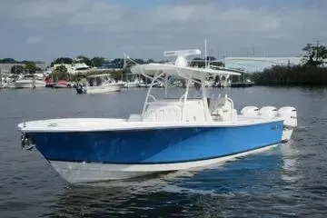 Slide: The Image of 2019 Regulator 34SS boat with blue hull on calm water. - 2