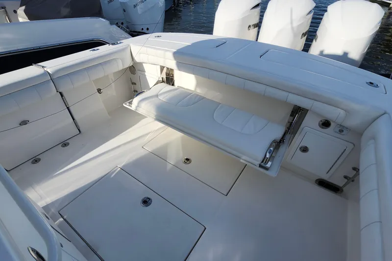Slide: The Image of 2019 Regulator 34SS boat interior with white seating and storage compartments. - 24