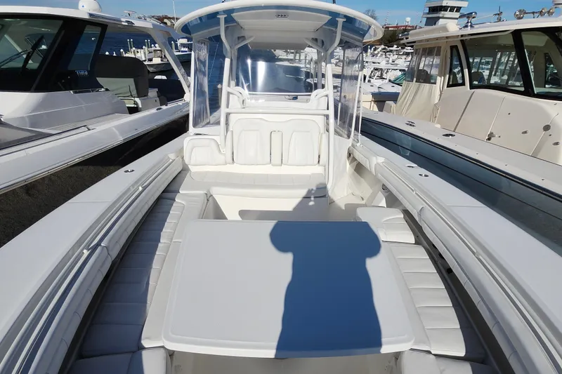 Slide: The Image of 2019 Regulator 34SS boat interior with seating and table, docked at marina. - 26
