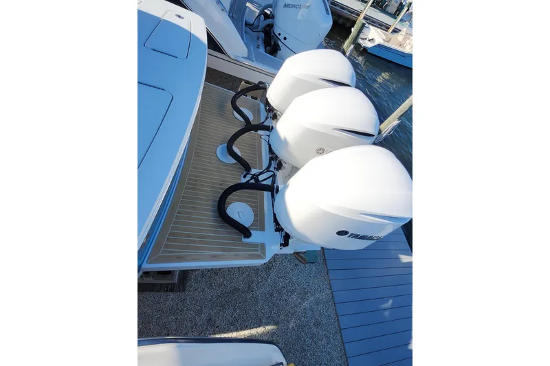 Slide: The Image of 2019 Regulator 34SS boat with triple Yamaha outboard engines at dock. - 37