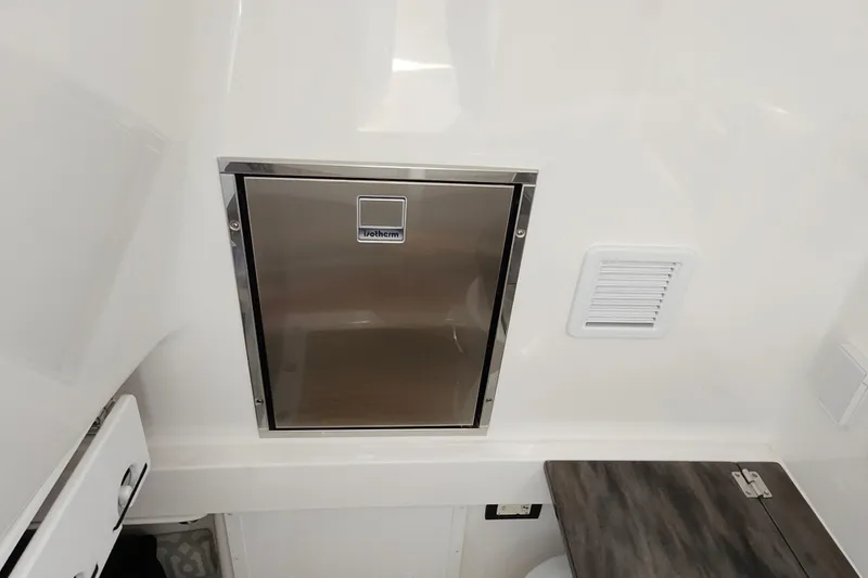 Slide: The Image of 2019 Regulator 34SS interior with stainless steel Isotherm fridge and ventilation panel. - 44
