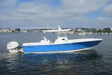 Slide: The Image of 2019 Regulator 34SS boat on water, blue hull, white deck, clear sky background. - 5
