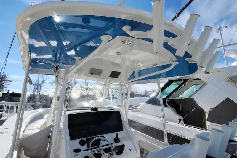 Slide: The Image of 2019 Regulator 34SS boat helm with blue T-top and rod holders. - 9