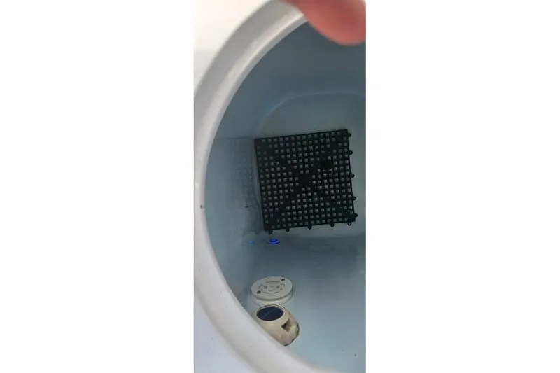 Slide: The Image of Open storage compartment on 2018 Sportsman Heritage 251 Center Console boat. - 13