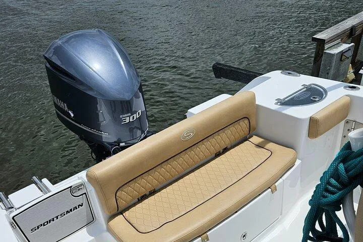 Slide: The Image of 2018 Sportsman Heritage 251 Center Console boat with Yamaha 300 engine, docked by water. - 17
