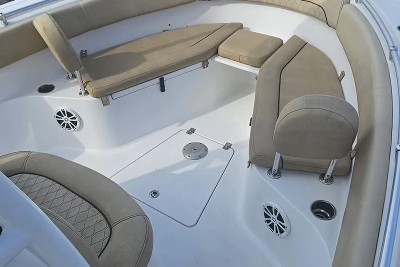 Slide: The Image of 2018 Sportsman Heritage 251 Center Console boat docked by a lake under clear skies. - 2