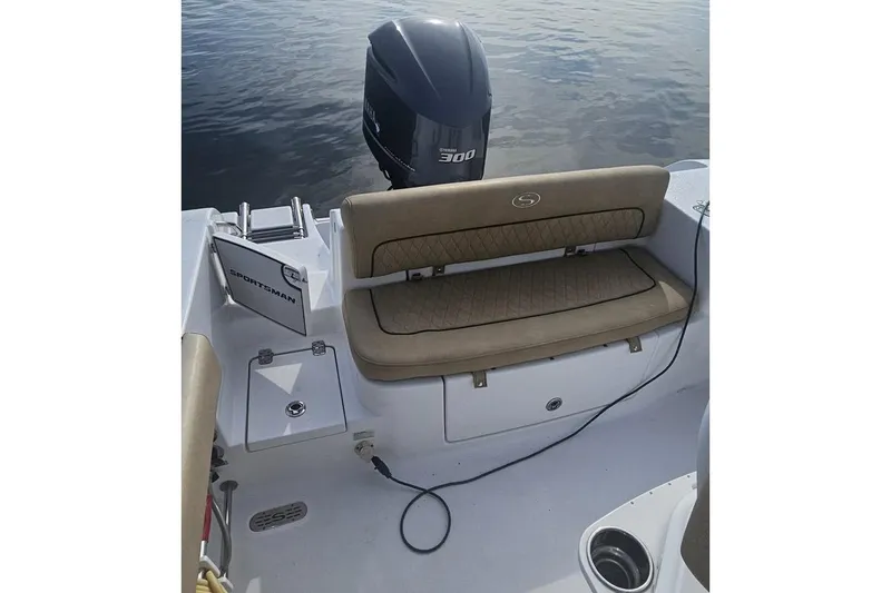 Slide: The Image of 2018 Sportsman Heritage 251 Center Console boat interior with beige seating and speakers. - 3