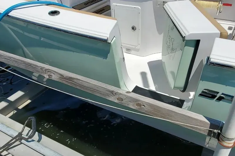 Slide: The Image of 2018 Sportsman Heritage 251 Center Console boat interior with seating and Yamaha engine. - 4