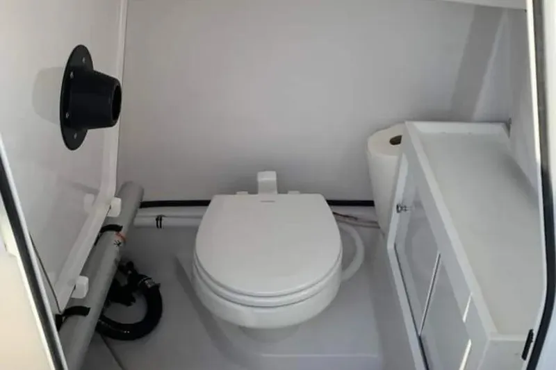 Slide: The Image of 2018 Sportsman Heritage 251 Center Console boat docked, featuring sleek design and modern amenities. - 5