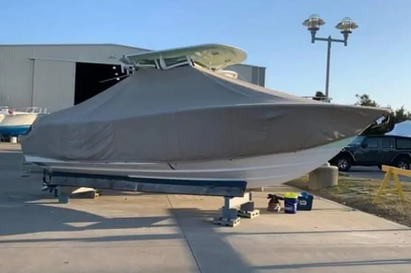 Slide: The Image of 2018 Sportsman Heritage 251 Center Console boat interior with seating and water view. - 8