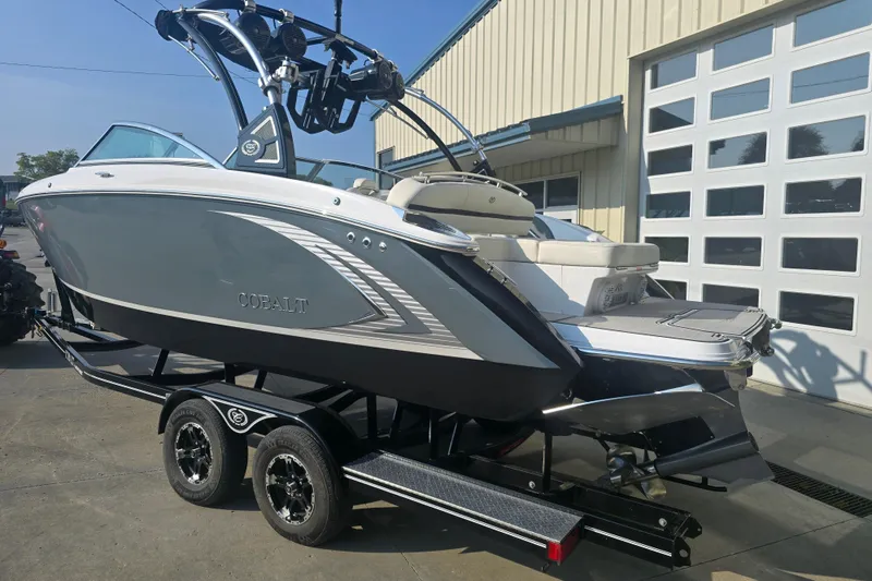 Slide: The Image of 2019 Cobalt R5 Surf boat on trailer, parked outside a garage. - 17