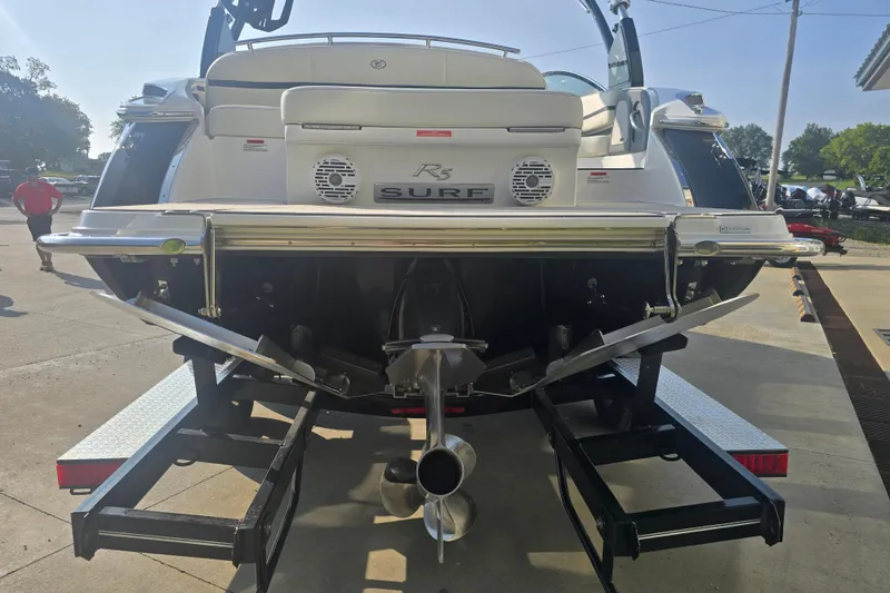 Slide: The Image of 2019 Cobalt R5 Surf boat rear view on trailer, showcasing propeller and swim platform. - 19