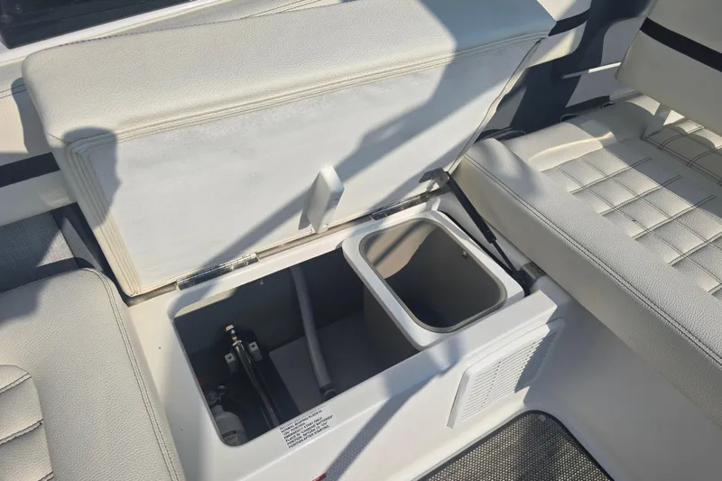Slide: The Image of 2019 Cobalt R5 Surf boat interior with open storage compartment and seating. - 28