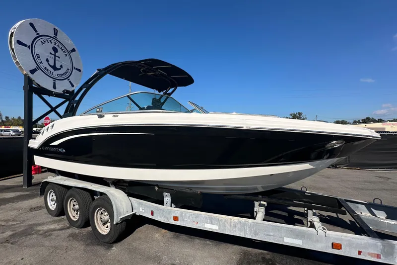 Slide: The Image of 2015 Chaparral 246 boat on trailer under clear blue sky. - 0