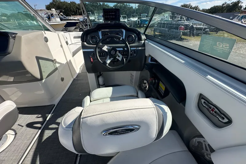Slide: The Image of Interior view of 2015 Chaparral 246 boat cockpit with steering wheel and seating. - 13