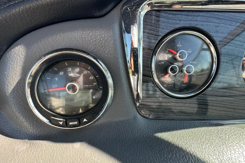 Slide: The Image of Dashboard gauges of a 2015 Chaparral 246 boat, featuring RPM and volt/temp indicators. - 16