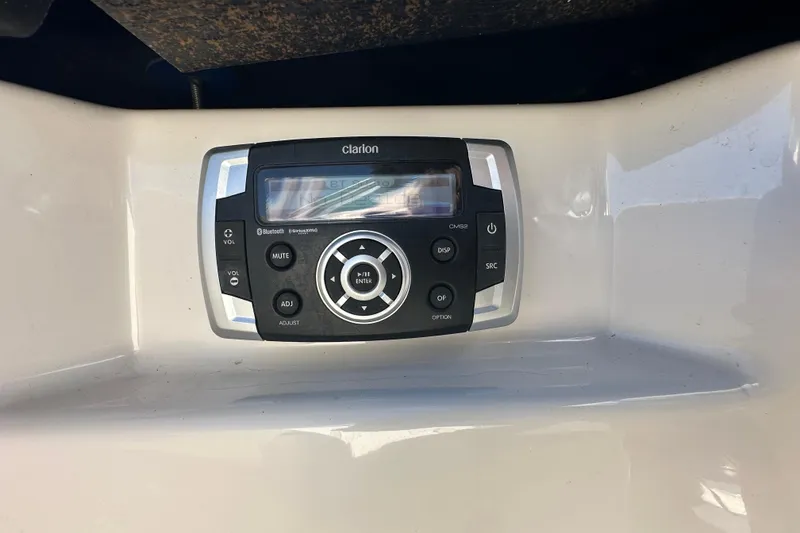 Slide: The Image of Clarion audio system on 2015 Chaparral 246 boat dashboard. - 24