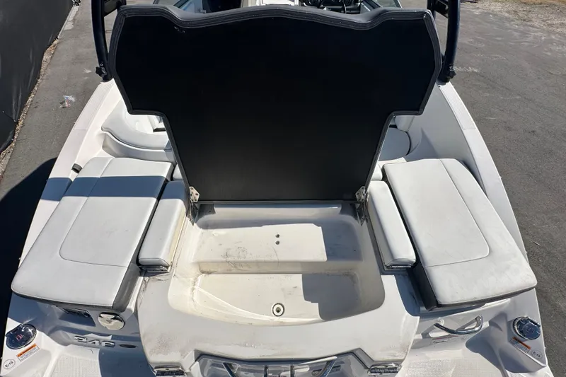 Slide: The Image of 2015 Chaparral 246 boat interior with open storage compartment and seating. - 26