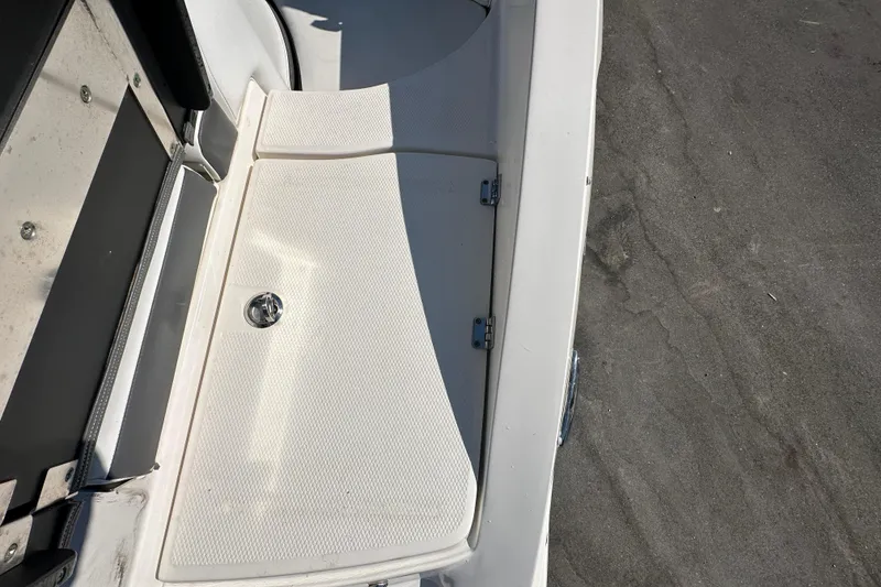 Slide: The Image of 2015 Chaparral 246 boat deck with storage compartment and latch. - 28