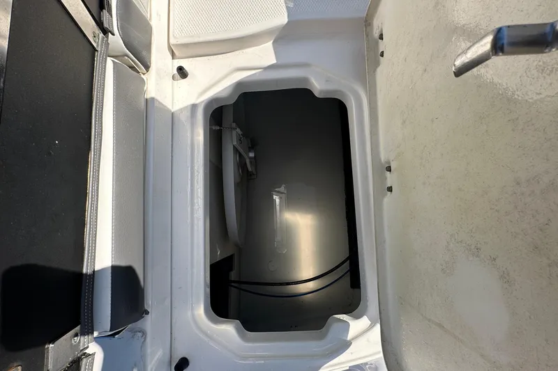 Slide: The Image of Open storage compartment on 2015 Chaparral 246 boat, showing interior details. - 29