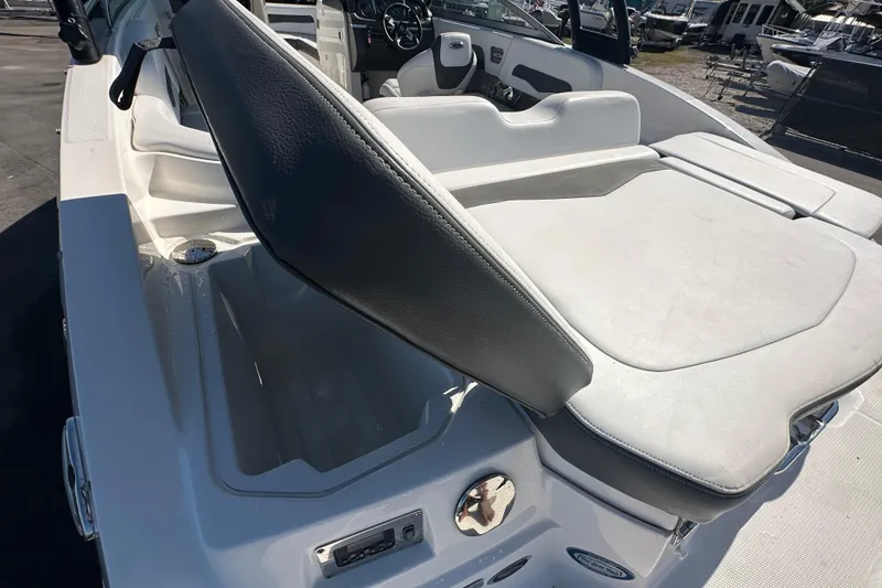Slide: The Image of 2015 Chaparral 246 boat interior with open storage compartment and seating area. - 30