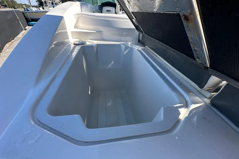 Slide: The Image of Open storage compartment on a 2015 Chaparral 246 boat, showing interior details. - 31