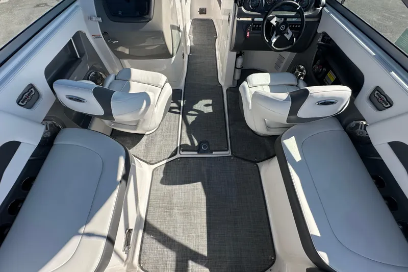 Slide: The Image of Interior of a 2015 Chaparral 246 boat with gray seating and steering wheel. - 34