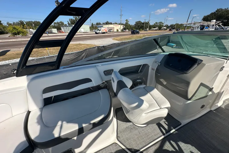 Slide: The Image of 2015 Chaparral 246 boat interior with white seating and modern dashboard. - 35
