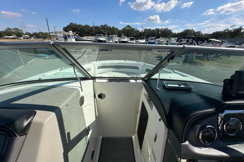 Slide: The Image of 2015 Chaparral 246 boat interior with open windshield and dashboard view. - 43
