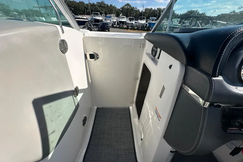 Slide: The Image of Interior view of a 2015 Chaparral 246 boat, showcasing cockpit and seating area. - 44