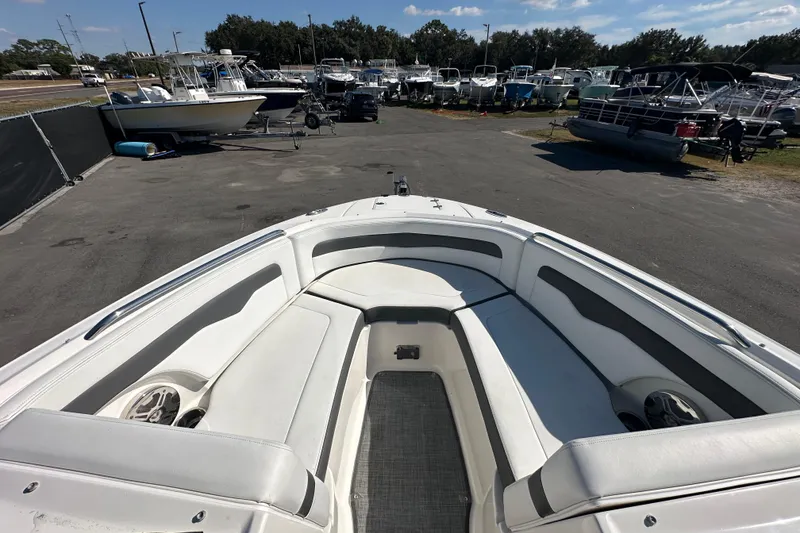 Slide: The Image of 2015 Chaparral 246 boat interior with seating, docked among other boats. - 49