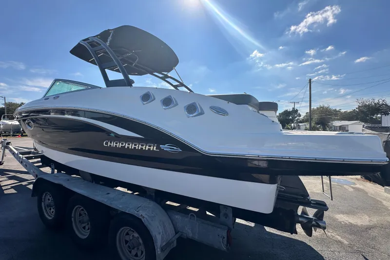 Slide: The Image of 2015 Chaparral 246 boat on trailer under sunny sky. - 5