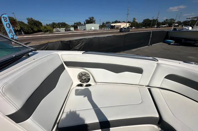 Slide: The Image of 2015 Chaparral 246 boat interior with white seating and cup holders. - 51