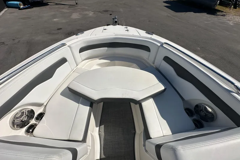 Slide: The Image of 2015 Chaparral 246 boat interior with white seating and cup holders. - 55