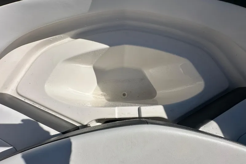Slide: The Image of 2015 Chaparral 246 boat interior detail, showing a clean, white storage compartment. - 57