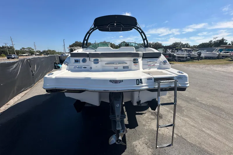 Slide: The Image of 2015 Chaparral 246 boat with swim platform and ladder, parked outdoors. - 6