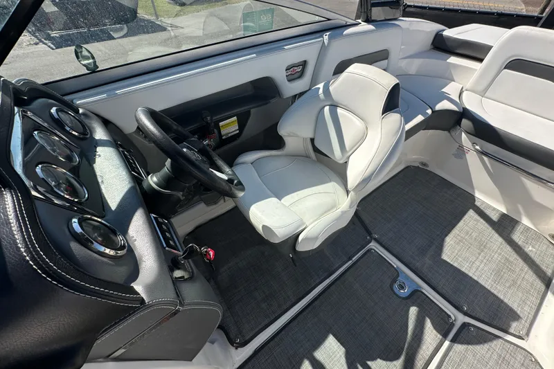 Slide: The Image of Interior of 2015 Chaparral 246 boat featuring steering wheel and seating area. - 68