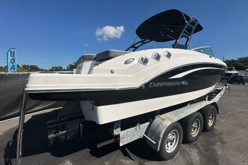 Slide: The Image of 2015 Chaparral 246 boat on a trailer under clear blue sky. - 8
