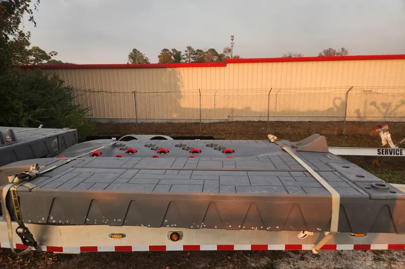 Slide: The Image of 2017 Sea-Doo GTI SE 130 on trailer, secured with straps, outdoor setting. - 12