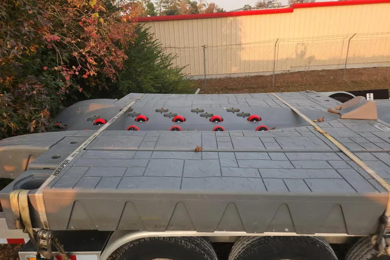 Slide: The Image of Trailer carrying a 2017 Sea-Doo GTI SE 130, secured with straps, near a fence. - 13