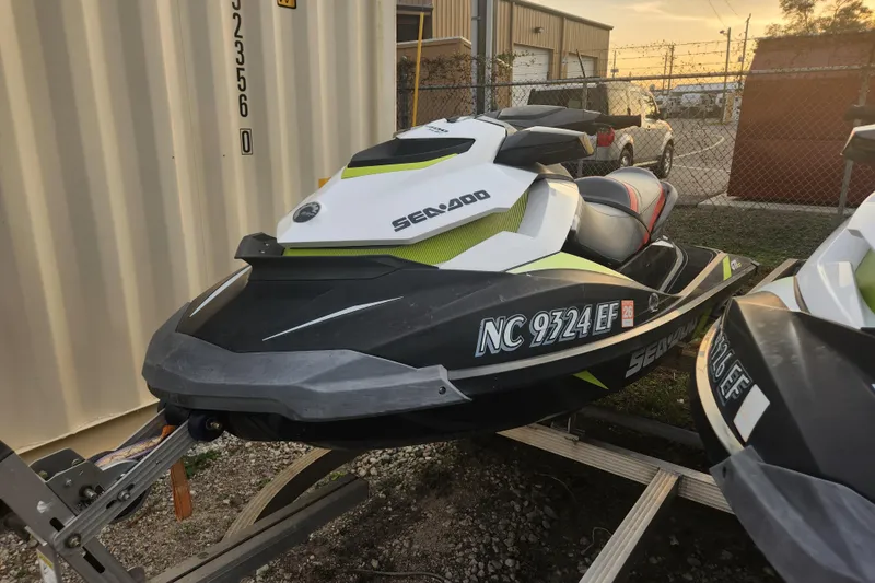 Slide: The Image of 2017 Sea-Doo GTI SE 130 jet ski parked on a trailer near a storage facility. - 2