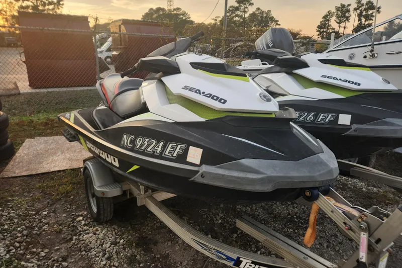 Slide: The Image of 2017 Sea-Doo GTI SE 130 jet ski on trailer, parked outdoors at sunset. - 3