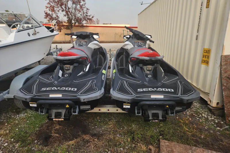 Slide: The Image of Two 2017 Sea-Doo GTI SE 130 jet skis on a trailer, parked outdoors. - 5