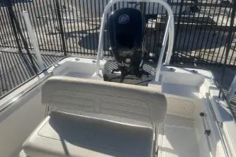 Slide: The Image of 2023 Boston Whaler 170 Montauk boat interior with seating and motor. - 11