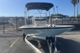 Slide: The Image of 2023 Boston Whaler 170 Montauk boat on trailer with canopy in sunny marina. - 3